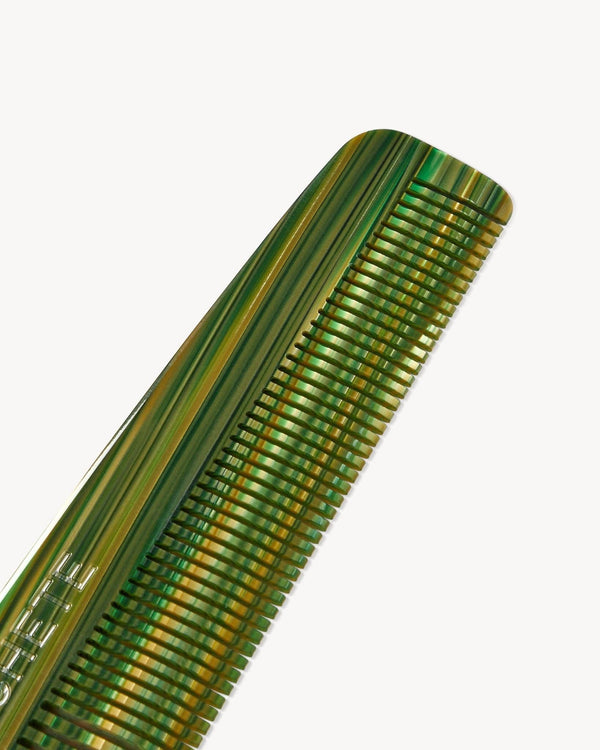 Green comb on a white background