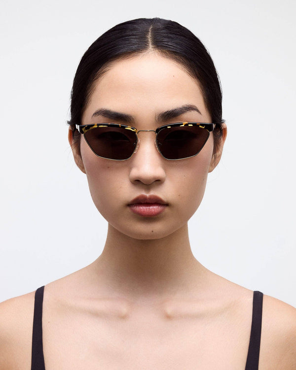 Woman wearing INDY NEW YORK sunglasses with a plain background